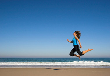 Women running along beach